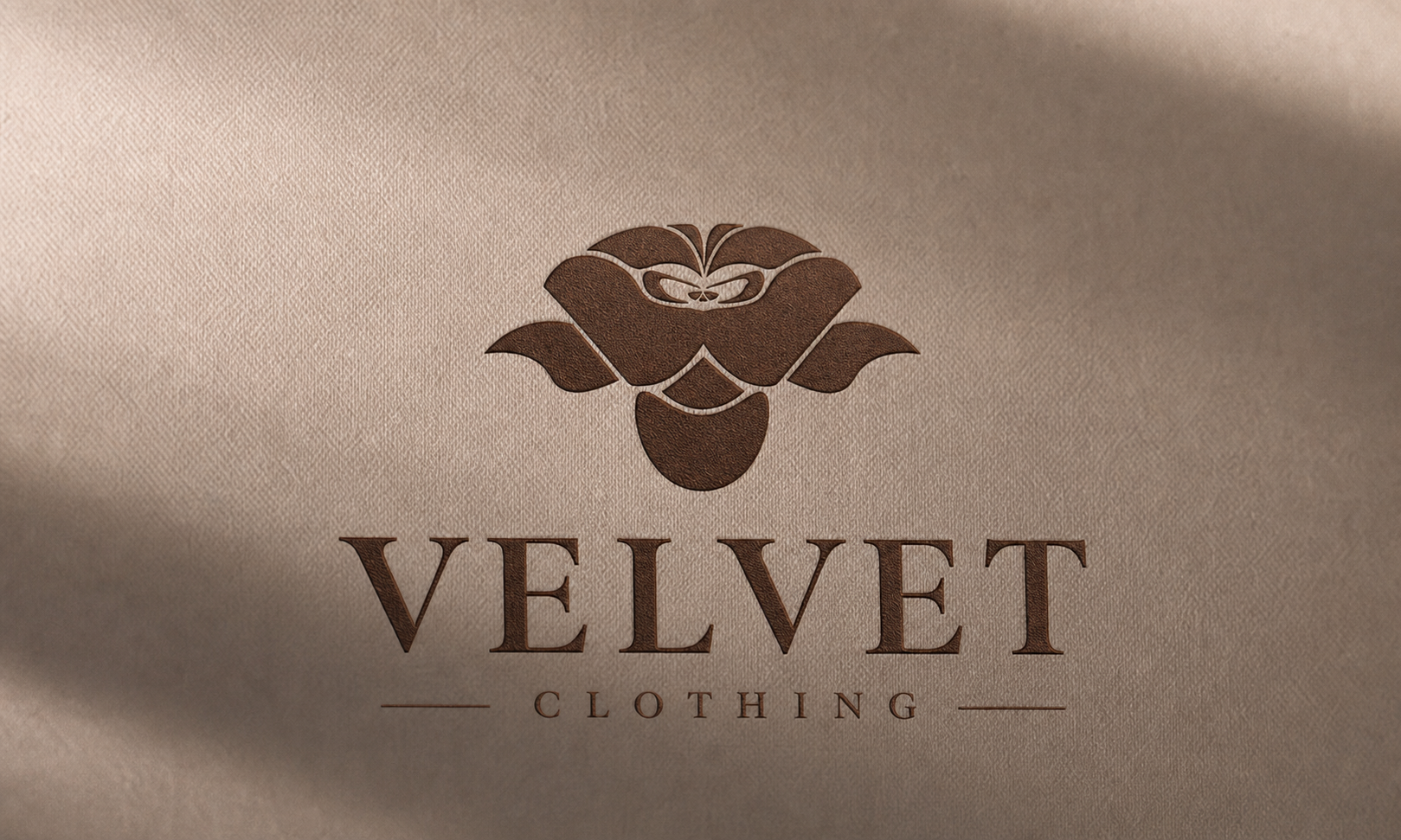 Velvet Clothing logo - a rose emblem above a serif wordmark, embossed on cream velvet.